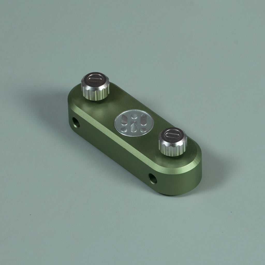 Green router circle-cutting jig with metal guide base and two adjustment knobs