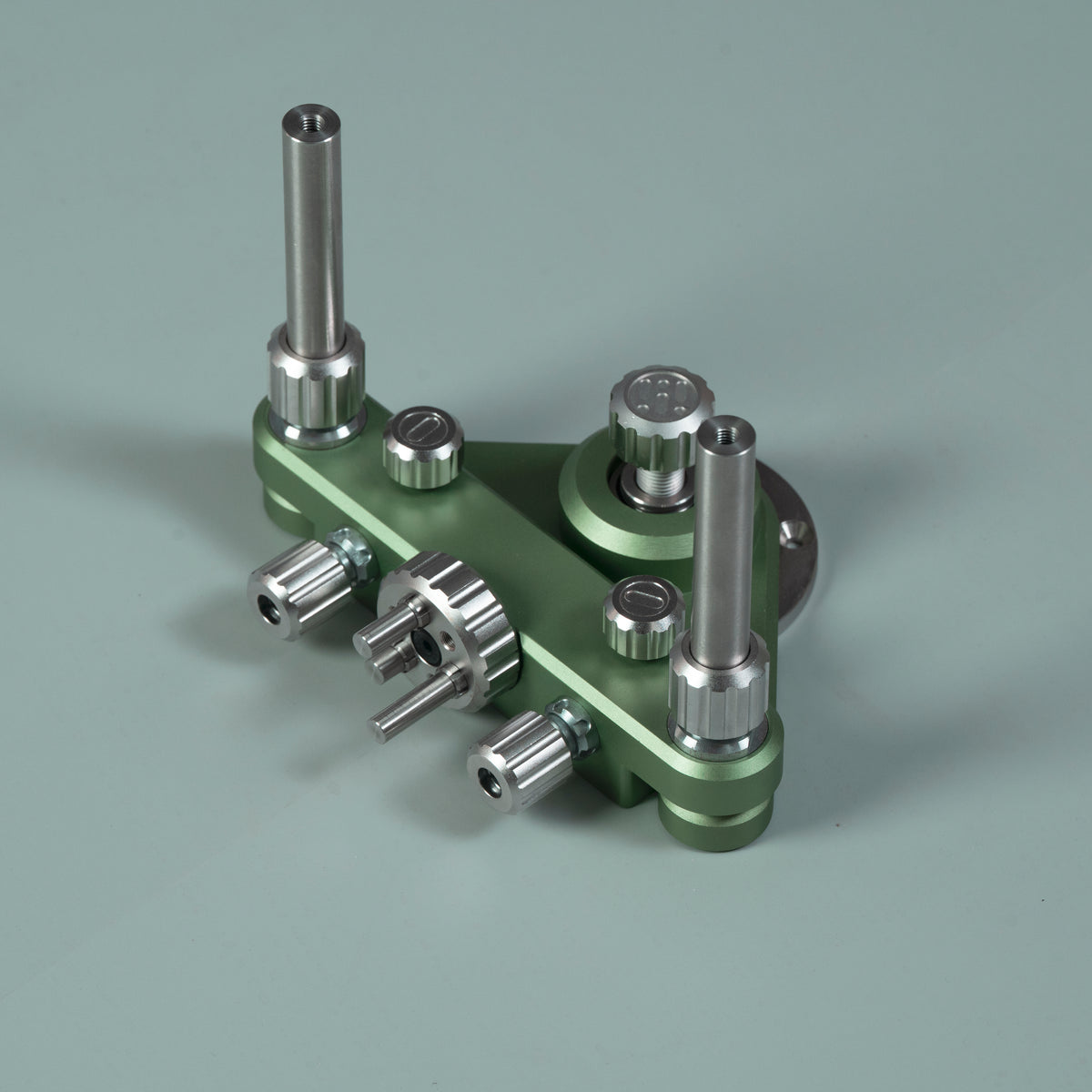 Green router circle-cutting jig with two tall guide posts and extra geared knobs on plate