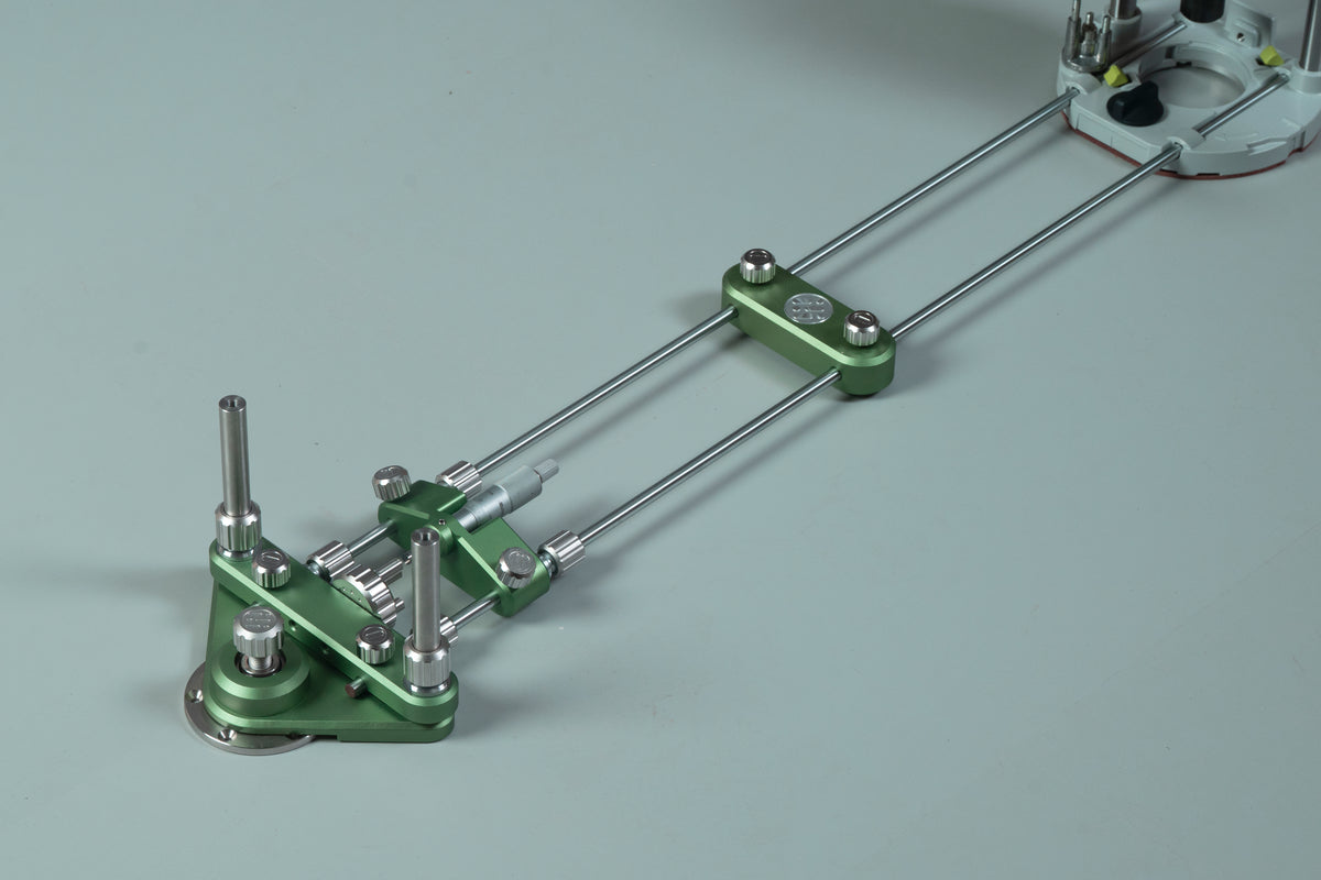 Router circle-cutting jig with green base, parallel guide rods, and mounted router unit