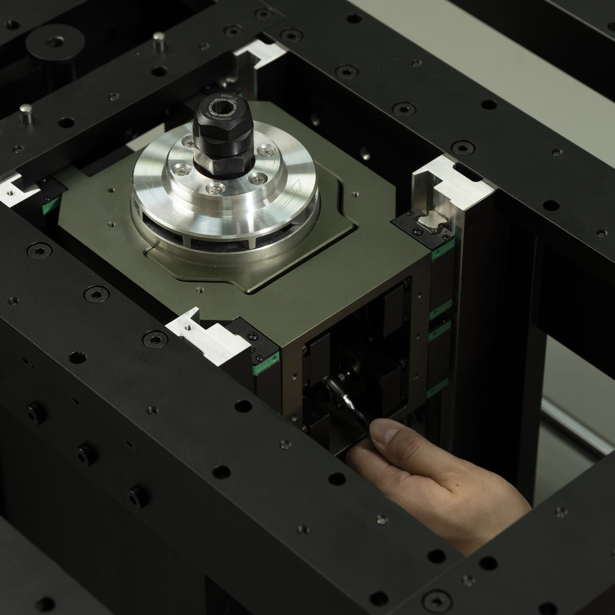 Modular routing platform spindle mount with silver router base and green sensor blocks